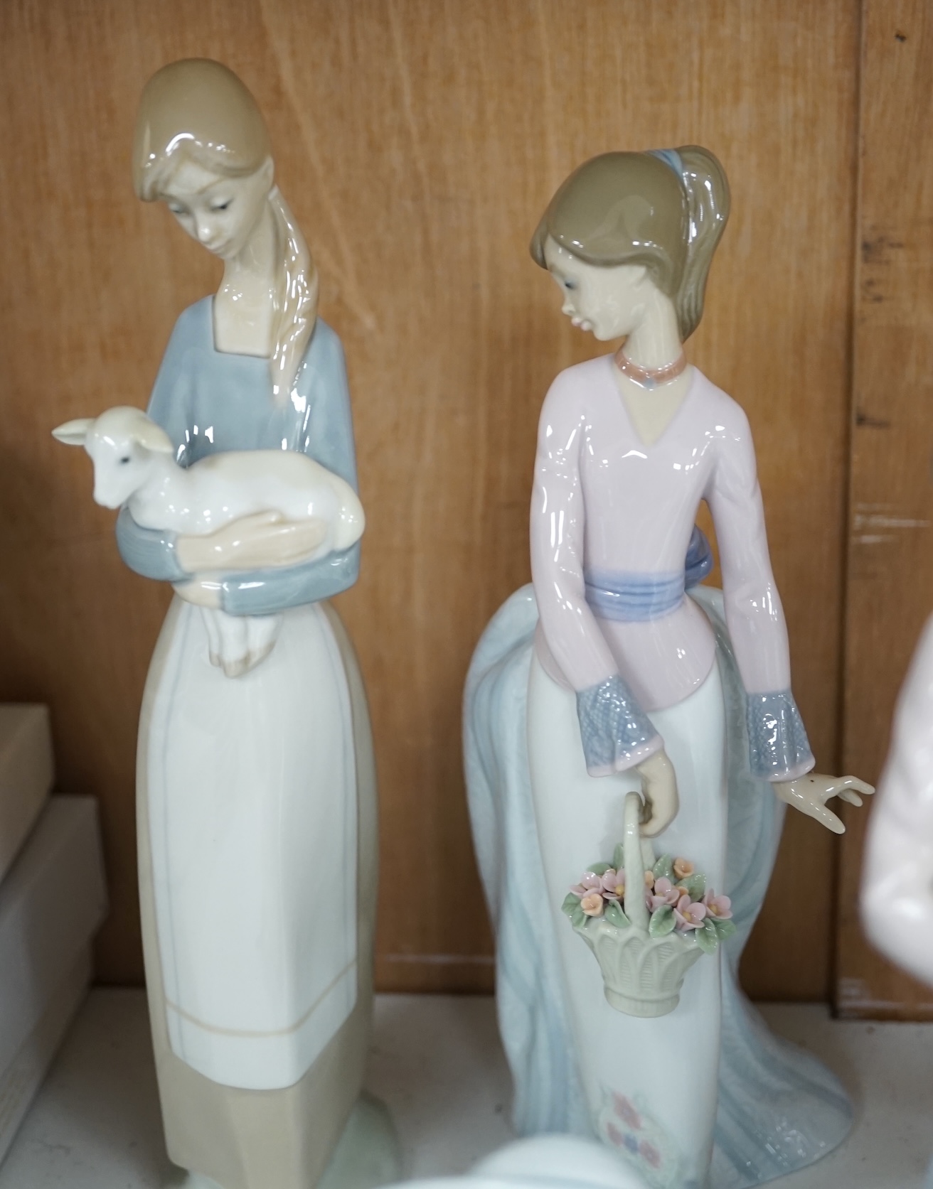 A group of Lladro figures to include ‘Lamplighter’ and ‘All aboard’, largest 48cm high. Condition - good